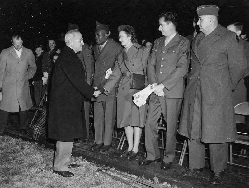 President Truman shakes hands with members of the military at Christmas