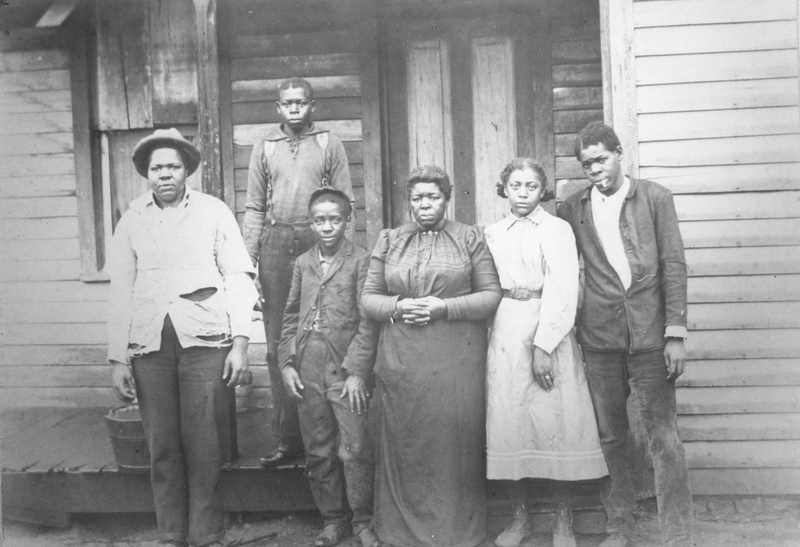 Photograph of a Negro family outside of a house | Harry S. Truman